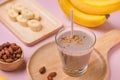 Fresh made Banana smoothie on pink background Royalty Free Stock Photo