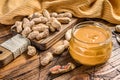 Fresh made creamy Peanut Butter in a glass jar. Wooden background. Top view Royalty Free Stock Photo