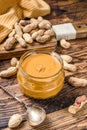 Fresh made creamy Peanut Butter in a glass jar. Wooden background. Top view Royalty Free Stock Photo