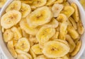 Portion of Dried Banana Chips on wooden background, selective focus Royalty Free Stock Photo