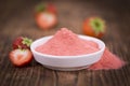 Strawberry powder on wooden background; selective focus