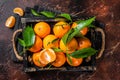 Fresh mandarin oranges or tangerines fruits with leaves. Dark background. Top view Royalty Free Stock Photo