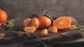 Fresh mandarin oranges or tangerines with leaves on textured dark background Royalty Free Stock Photo