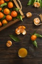 Fresh tangerine oranges on a wooden table. Peeled mandarin. Halves, slices and whole clementines closeup.