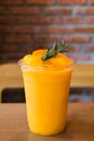 Fresh mandarin smoothie in glass