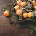 Fresh mandarins with leaves on wooden board. Christmas composition with copy space Royalty Free Stock Photo