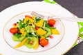 Fresh mango, arugula, kiwi, orange and pomegranate. Royalty Free Stock Photo