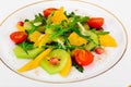 Fresh mango, arugula, kiwi, orange and pomegranate. Royalty Free Stock Photo