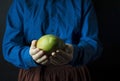 Fresh mango in the hands of the cook. Exotic fruit. Ripe mango. Balanced diet. Dark background. Space for text Royalty Free Stock Photo