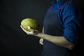 Fresh mango in the hands of the cook. Exotic fruit. Ripe mango. Balanced diet. Dark background. Space for text Royalty Free Stock Photo