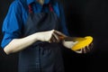 Fresh mango in the hands of the cook. Exotic fruit. Ripe mango. Balanced diet. Dark background. Space for text Royalty Free Stock Photo