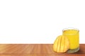 Fresh mango juice with ripe sliced mangoes on a wooden table isolated on white background Royalty Free Stock Photo