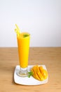Fresh Mango juice smoothie and mango fruit with bamboo basket
