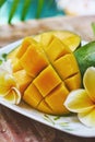 Fresh mango on a wooden tabel with tropical background. Soft focus. Royalty Free Stock Photo