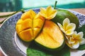 Fresh mango on a wooden tabel with tropical background. Soft focus. Royalty Free Stock Photo