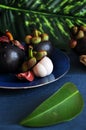 Fresh Mangosteen with Mangosteen Leaf on Blue Background