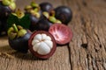 Fresh Mangosteen on old wood baclground. Mangosteen has been known as The Queen of Fruits