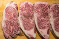 Fresh marbled wagyu beef ribeye steak seasoning with pepper and salt before grill