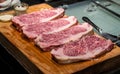 Fresh marbled wagyu beef ribeye steak on wooden board