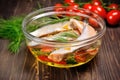 fresh marinated fish fillets in a glass bowl