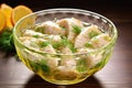 fresh marinated fish fillets in a glass bowl