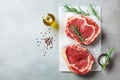 Fresh meat on kitchen table top view. Raw beef steak and spices for cooking Royalty Free Stock Photo