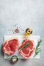 Fresh meat on kitchen table top view. Raw beef steak and spices for cooking Royalty Free Stock Photo