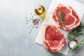 Fresh meat on kitchen table top view. Raw beef steak and spices for cooking Royalty Free Stock Photo