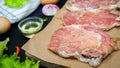 Fresh meat. Raw pork steak with spices on black background Royalty Free Stock Photo