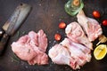 Fresh meat. Raw turkey fillet and shin, tomatoes, olive oil, spices and lemons on a stone table.