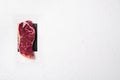 Fresh meat, vacuum-Packed marbled beef, New York strip steak, on white stone table background, top view flat lay, with copy space Royalty Free Stock Photo