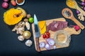 Fresh meats on a cutting board with vegetables and spices. Royalty Free Stock Photo