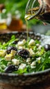 Fresh Mediterranean Salad with Spinach, Feta Cheese, Black Olives, and Olive Oil Pouring from Glass Bottle Royalty Free Stock Photo