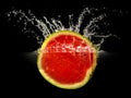 Fresh melon falling in water with splash on black background Royalty Free Stock Photo