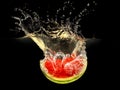 Fresh melon falling in water with splash on black Royalty Free Stock Photo