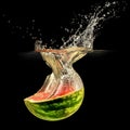 Fresh melon falling in water with splash on black Royalty Free Stock Photo