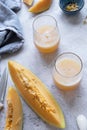 Fresh melon juice on the table with cloudy sky background, preparing melon juice by raw ripe biological fruit Royalty Free Stock Photo