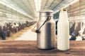 Fresh milk bottle and can on the table in cowshed Royalty Free Stock Photo