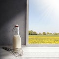 Fresh milk,cream bottle on window sill in countryside Royalty Free Stock Photo
