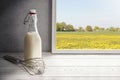 Fresh milk,cream bottle on window sill in countryside Royalty Free Stock Photo