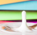 Fresh milk droplet isolated on interesting colourful background - dairy products - lactose intolerance