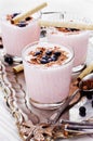 Fresh milkshake, yogurt, dessert, smoothie with strawberry decorated grated chocolate and frozen blueberries