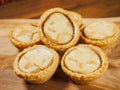 Fresh mince pies on a wooden board. Traditional Christmas pastry product