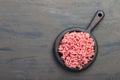 Fresh minced beef on cutting board on dark background with ingredients for cooking top view Royalty Free Stock Photo