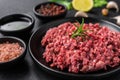 Fresh minced meat ground beef on a black plate against stone background. Royalty Free Stock Photo