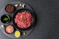 Fresh minced meat ground beef on a black plate against stone background. Royalty Free Stock Photo