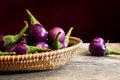 Fresh mini purple eggplant in the basket on wooden background Royalty Free Stock Photo