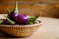 Fresh mini purple eggplant in the basket on wooden background Royalty Free Stock Photo