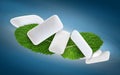 Fresh mint leaves and chewing gum pads flying on blue background Royalty Free Stock Photo