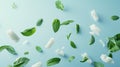 fresh mint leaves and chewing gum pads gracefully falling against a light blue background, evoking a sense of freshness Royalty Free Stock Photo